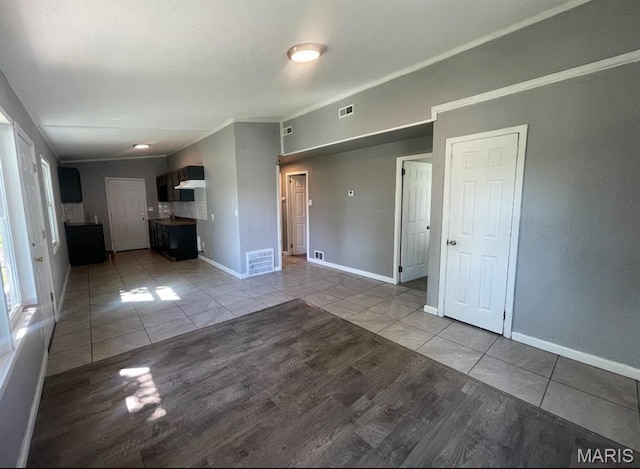 1115 Saint Michael Dr, Cahokia, IL 62206 - unfurnished living room featuring light tile patterned flooring and ornamental molding