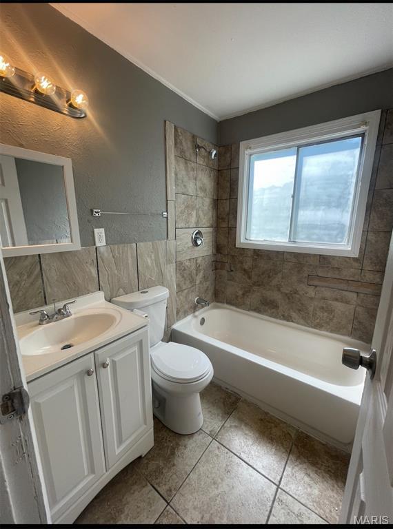 1115 Saint Michael Dr, Cahokia, IL 62206 - bathroom featuring vanity, tile patterned floors, bathtub / shower combination, and tile walls