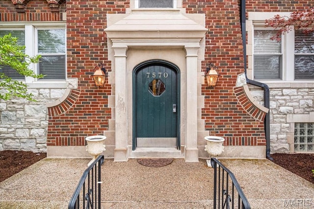 7570 Byron Pl Unit 3W, Saint Louis, MO 63105 - doorway to property with brick siding and stone siding