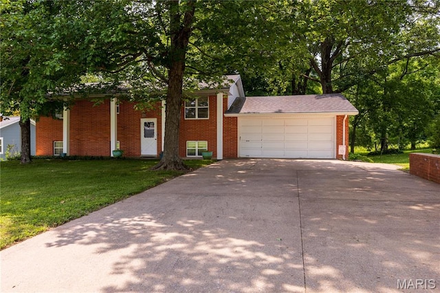 1131 Kimbel Ln, Jackson, MO 63755 - view of front facade featuring brick siding, concrete driveway, a front yard, and a garage
