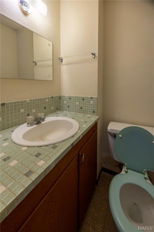 1131 Kimbel Ln, Jackson, MO 63755 - bathroom featuring vanity and tasteful backsplash
