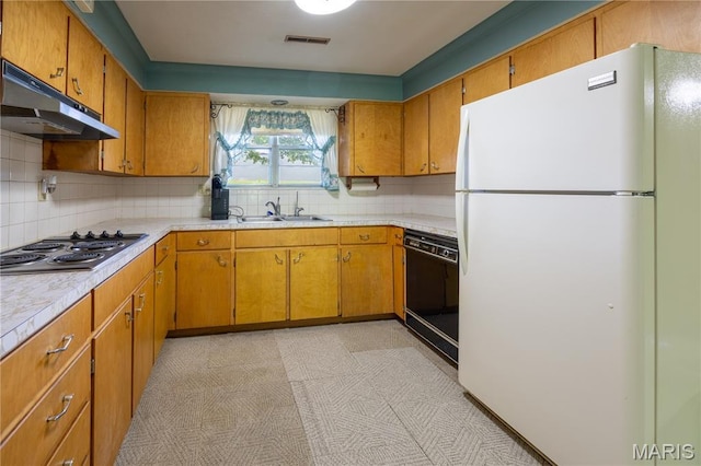 1131 Kimbel Ln, Jackson, MO 63755 - kitchen with freestanding refrigerator, dishwasher, stainless steel electric cooktop, light countertops, and under cabinet range hood