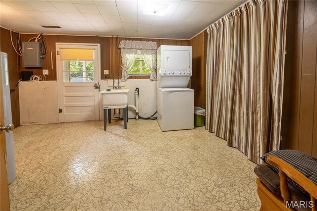1131 Kimbel Ln, Jackson, MO 63755 - washroom featuring stacked washer / dryer, electric panel, and wood walls