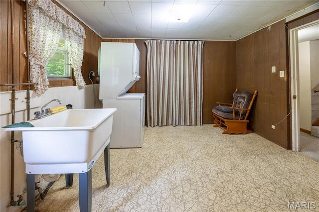 1131 Kimbel Ln, Jackson, MO 63755 - laundry area featuring stacked washer and clothes dryer and wood walls