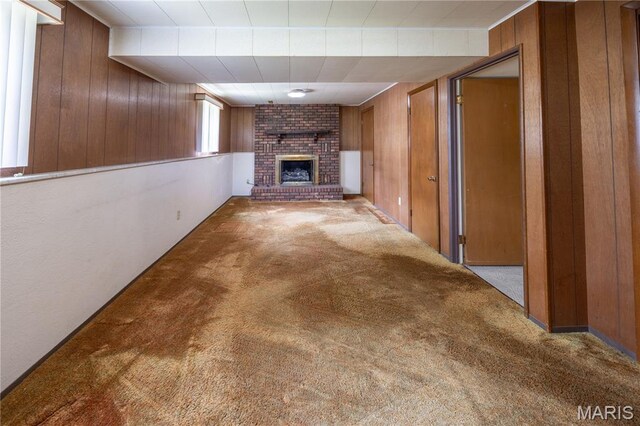 1131 Kimbel Ln, Jackson, MO 63755 - unfurnished living room featuring wood walls, carpet flooring, and a fireplace