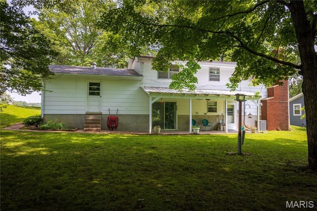 1131 Kimbel Ln, Jackson, MO 63755 - back of property featuring a lawn and a patio area