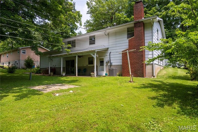 1131 Kimbel Ln, Jackson, MO 63755 - rear view of house with a chimney, a yard, a ceiling fan, and a patio area