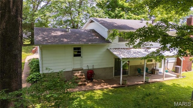 1131 Kimbel Ln, Jackson, MO 63755 - back of house featuring a yard, a patio, and a shingled roof