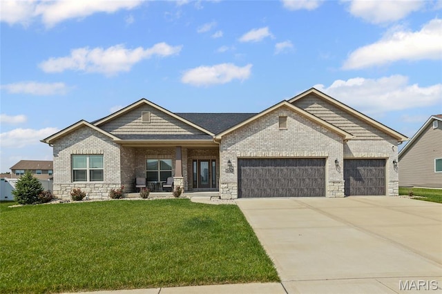2626 Waldon Ln, Belleville, IL 62221 - craftsman inspired home featuring a garage, a front yard, concrete driveway, covered porch, and stone siding