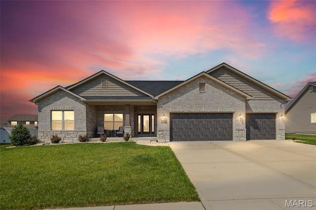 2626 Waldon Ln, Belleville, IL 62221 - view of front of property featuring a garage, a yard, driveway, covered porch, and brick siding