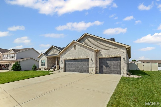2626 Waldon Ln, Belleville, IL 62221 - view of front of house featuring an attached garage, driveway, a gate, and stone siding