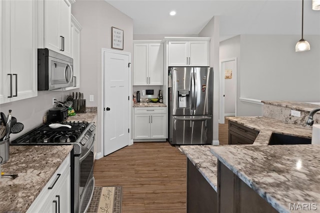 2626 Waldon Ln, Belleville, IL 62221 - kitchen featuring stainless steel appliances, wood finished floors, white cabinetry, light stone counters, and hanging light fixtures