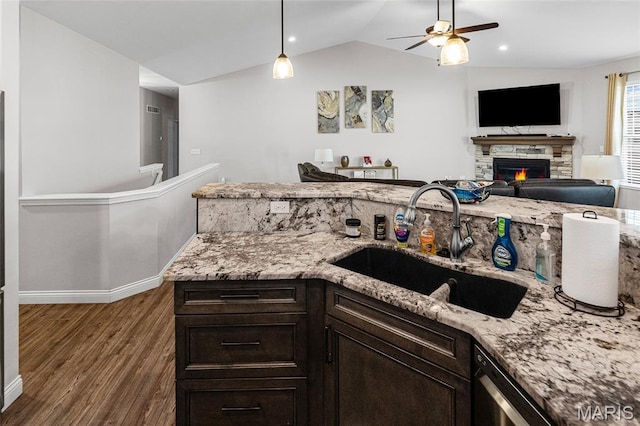 2626 Waldon Ln, Belleville, IL 62221 - kitchen featuring a ceiling fan, wood finished floors, light stone countertops, vaulted ceiling, and a fireplace
