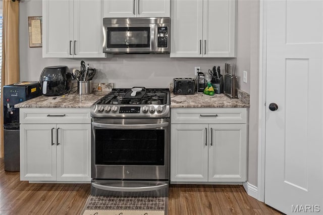 2626 Waldon Ln, Belleville, IL 62221 - kitchen with stainless steel appliances, wood finished floors, white cabinets, and light stone counters