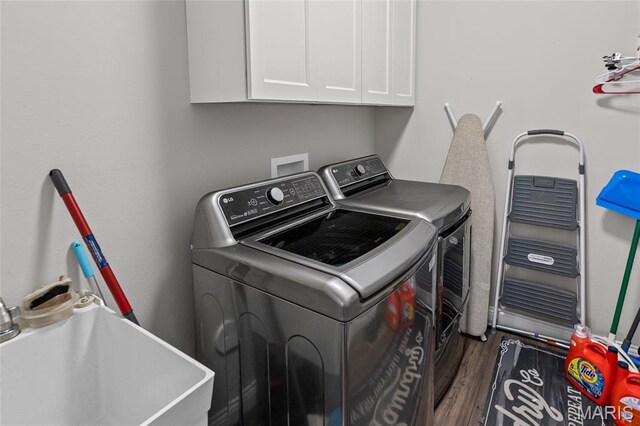 2626 Waldon Ln, Belleville, IL 62221 - washroom featuring washer and dryer, cabinet space, and wood finished floors