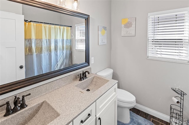 2626 Waldon Ln, Belleville, IL 62221 - bathroom with double vanity, wood finished floors, and a shower with curtain