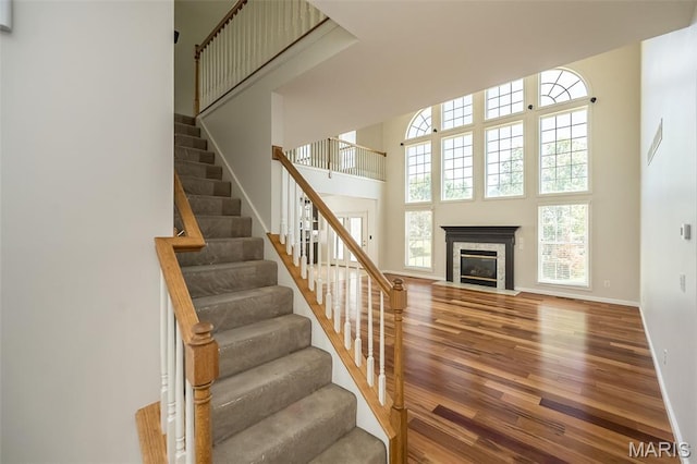 86 Homefield Square Ct, Ofallon, MO 63366 - stairway with a towering ceiling, wood finished floors, and a tile fireplace