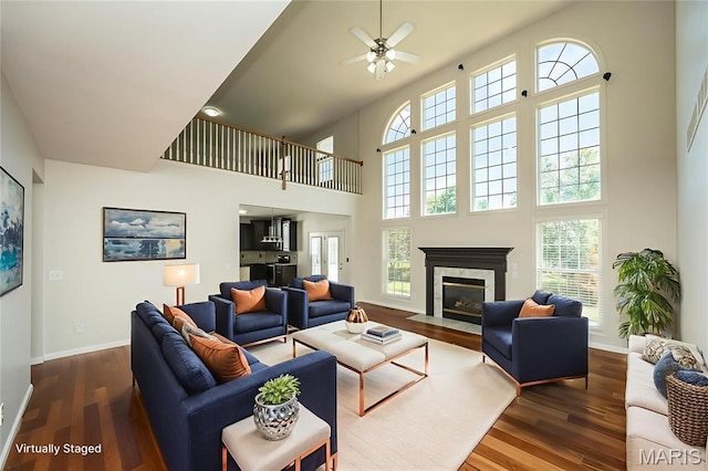 86 Homefield Square Ct, Ofallon, MO 63366 - living room with a towering ceiling, ceiling fan, dark wood-type flooring, and a fireplace