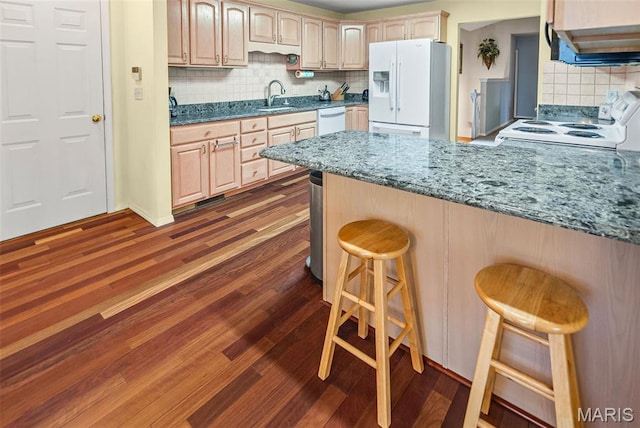 829 Clemson Ave, Fairview Heights, IL 62208 - kitchen with white appliances, tasteful backsplash, dark wood-style flooring, a peninsula, and a breakfast bar area