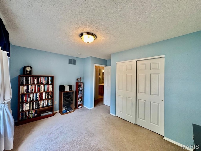 829 Clemson Ave, Fairview Heights, IL 62208 - bedroom featuring carpet flooring, a closet, and a textured ceiling