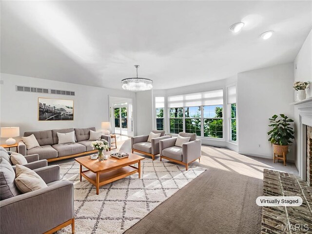 596 Eagle Manor Ln, Chesterfield, MO 63017 - living area with a chandelier, a brick fireplace, and light colored carpet