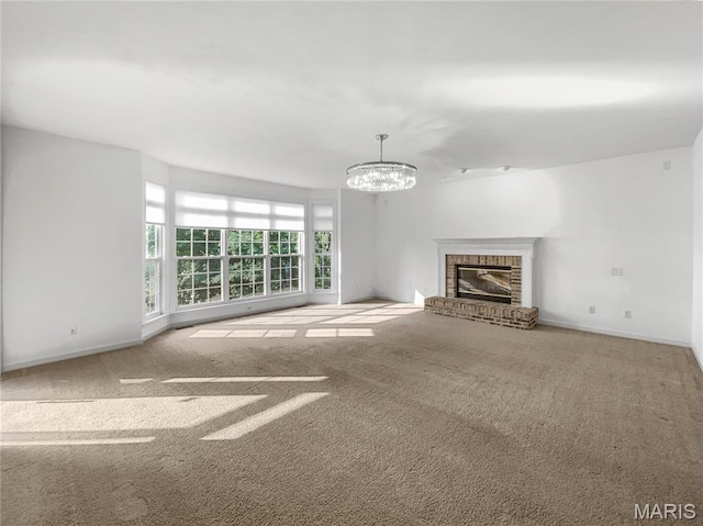 596 Eagle Manor Ln, Chesterfield, MO 63017 - unfurnished living room featuring carpet, a chandelier, and a brick fireplace