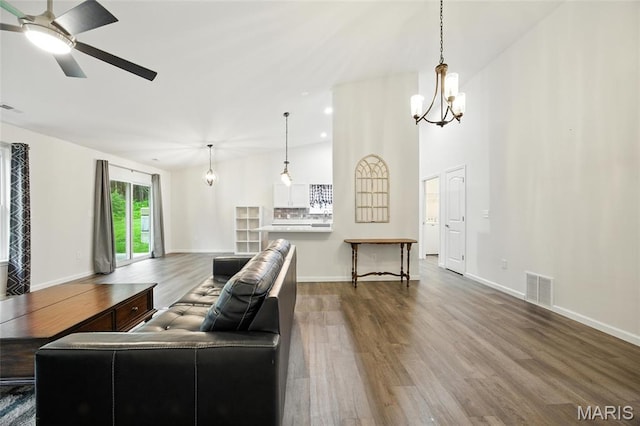 1575 Hickory Lndg, De Soto, MO 63020 - living room featuring wood finished floors, a ceiling fan, and a chandelier