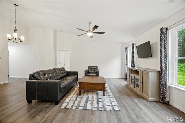 1575 Hickory Lndg, De Soto, MO 63020 - living area featuring wood finished floors, a chandelier, lofted ceiling, and a ceiling fan