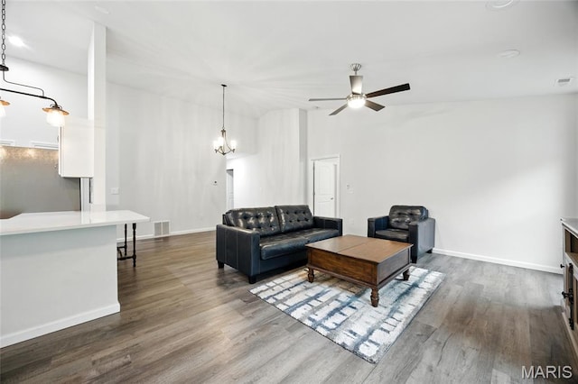 1575 Hickory Lndg, De Soto, MO 63020 - living room featuring a ceiling fan, dark wood finished floors, a chandelier, and lofted ceiling