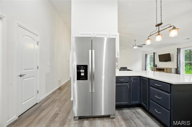 1575 Hickory Lndg, De Soto, MO 63020 - kitchen with stainless steel fridge with ice dispenser, a peninsula, light countertops, light wood-type flooring, and ceiling fan