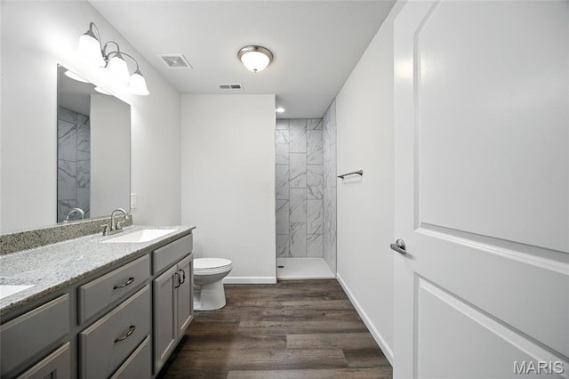 1575 Hickory Lndg, De Soto, MO 63020 - full bathroom with double vanity, a marble finish shower, and wood finished floors