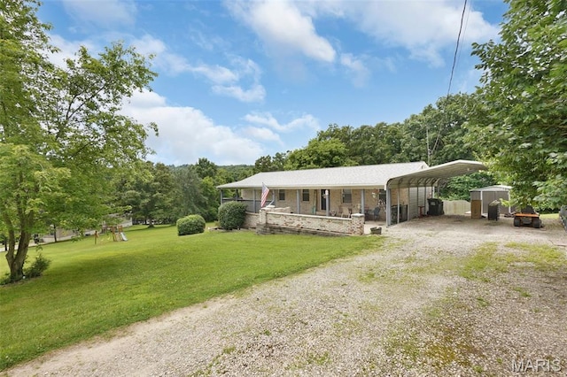 351 Orion Dr, De Soto, MO 63020 - view of front facade with gravel driveway, a carport, a front yard, and a porch