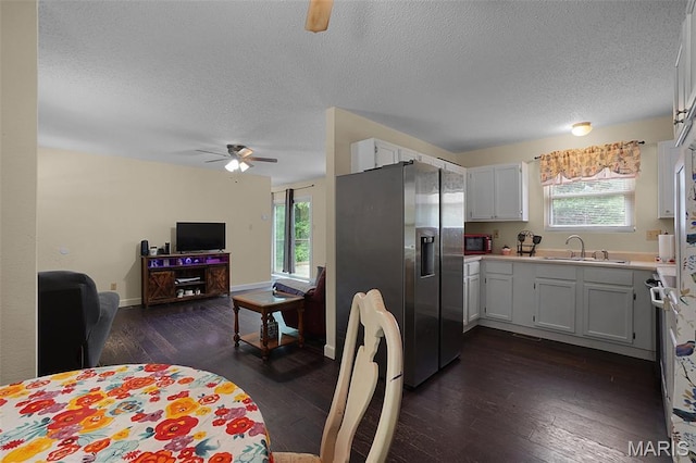 351 Orion Dr, De Soto, MO 63020 - kitchen featuring stainless steel refrigerator with ice dispenser, ceiling fan, a textured ceiling, dark wood-style flooring, and healthy amount of natural light