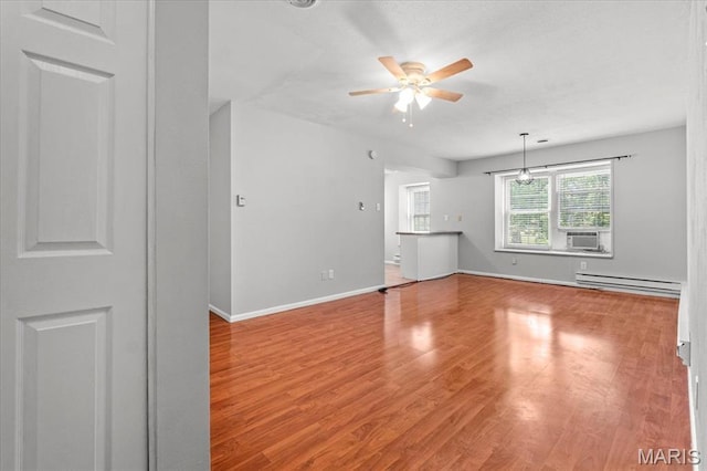 1745 Herault Pl Unit F, Saint Louis, MO 63125 - unfurnished room with baseboard heating, a ceiling fan, wood finished floors, and cooling unit