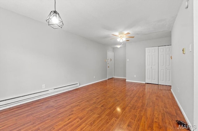 1745 Herault Pl Unit F, Saint Louis, MO 63125 - unfurnished living room featuring a baseboard radiator, ceiling fan, and wood finished floors