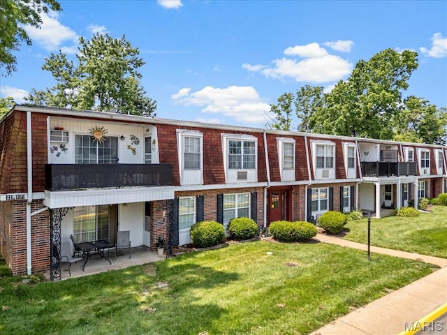 1745 Herault Pl Unit F, Saint Louis, MO 63125 - view of front of house with a front yard, a patio area, and brick siding