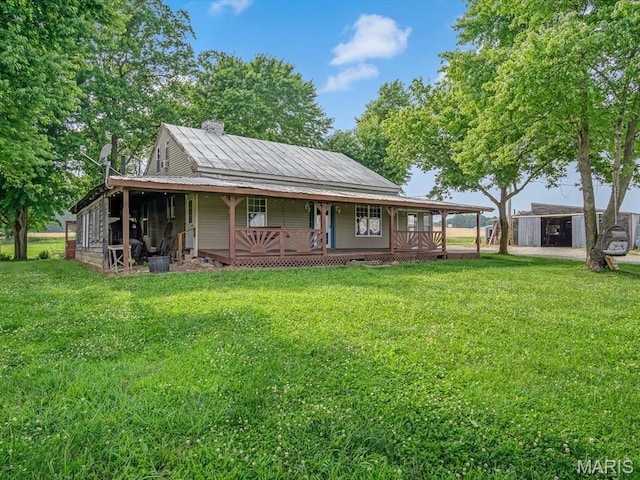 1767 Ames Rd, Prairie Du Rocher, IL 62277 - farmhouse inspired home featuring a porch, a front yard, a storage shed, and a metal roof