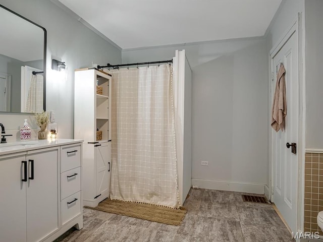 1767 Ames Rd, Prairie Du Rocher, IL 62277 - full bathroom with vanity, wood finished floors, and a shower with curtain