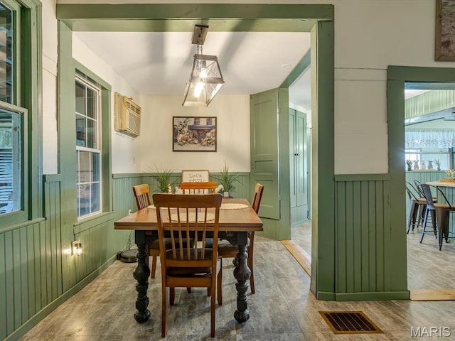 1767 Ames Rd, Prairie Du Rocher, IL 62277 - dining area with a wall mounted AC, wainscoting, and wood finished floors