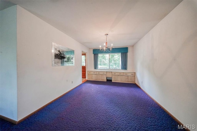 10820 Clayton Ct, Rolla, MO 65401 - spare room featuring a chandelier and dark carpet