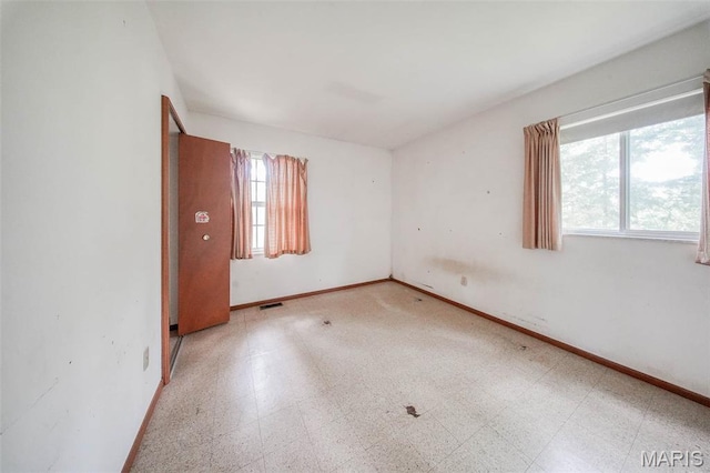 10820 Clayton Ct, Rolla, MO 65401 - empty room featuring tile patterned floors and baseboards