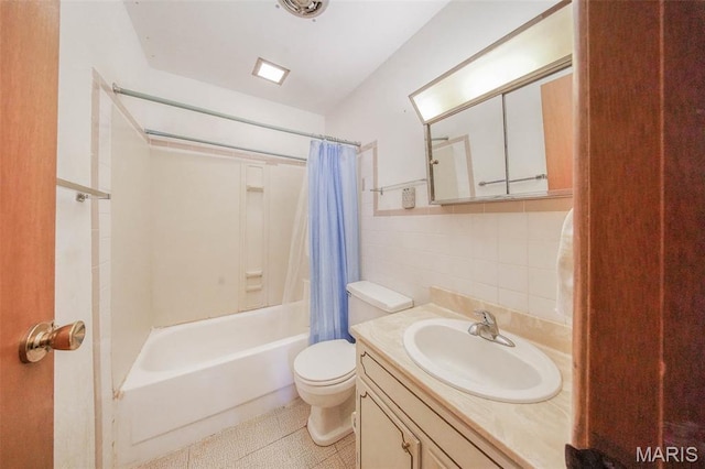 10820 Clayton Ct, Rolla, MO 65401 - full bath with vanity, shower / bath combination with curtain, backsplash, and tile walls
