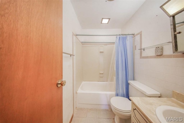 10820 Clayton Ct, Rolla, MO 65401 - full bathroom featuring tile walls, shower / bath combination with curtain, vanity, and tile patterned floors