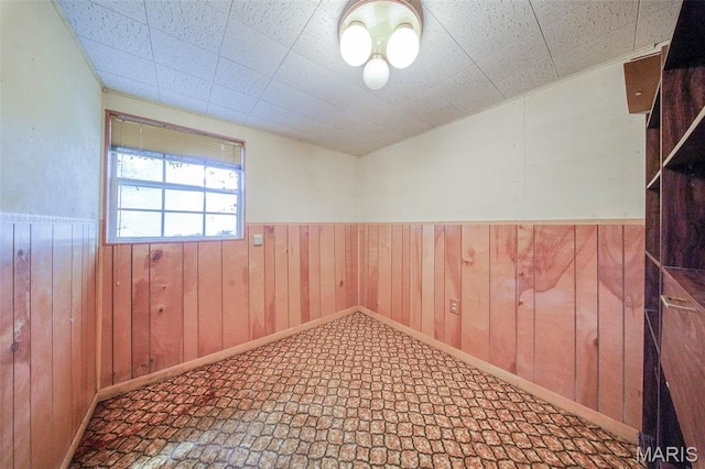 10820 Clayton Ct, Rolla, MO 65401 - empty room featuring a wainscoted wall and wood walls