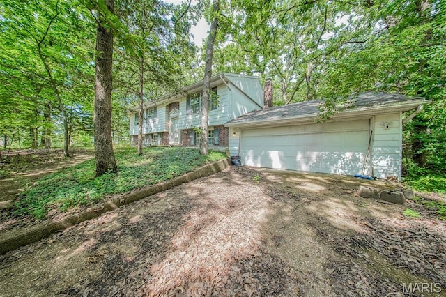 10820 Clayton Ct, Rolla, MO 65401 - view of front facade with a chimney and a garage
