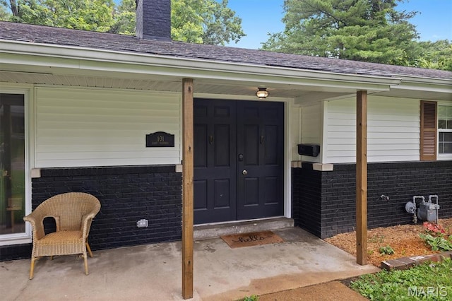 101 E Fairway Dr, Belleville, IL 62223 - entrance to property featuring brick siding, a chimney, and a shingled roof