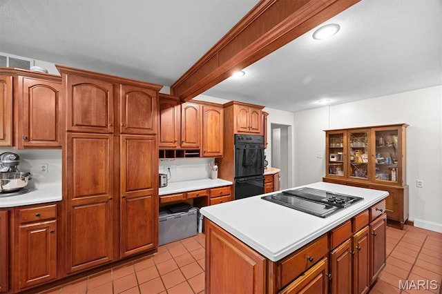 101 E Fairway Dr, Belleville, IL 62223 - kitchen with black appliances, light tile patterned floors, light countertops, and brown cabinetry