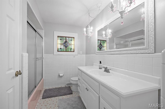 101 E Fairway Dr, Belleville, IL 62223 - full bath with tile walls, a chandelier, vanity, a wainscoted wall, and tile patterned floors