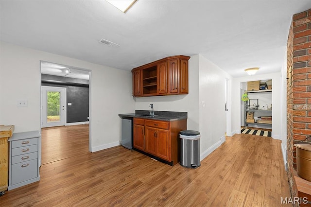 101 E Fairway Dr, Belleville, IL 62223 - kitchen featuring dishwasher, light wood-style flooring, open shelves, brown cabinetry, and dark countertops