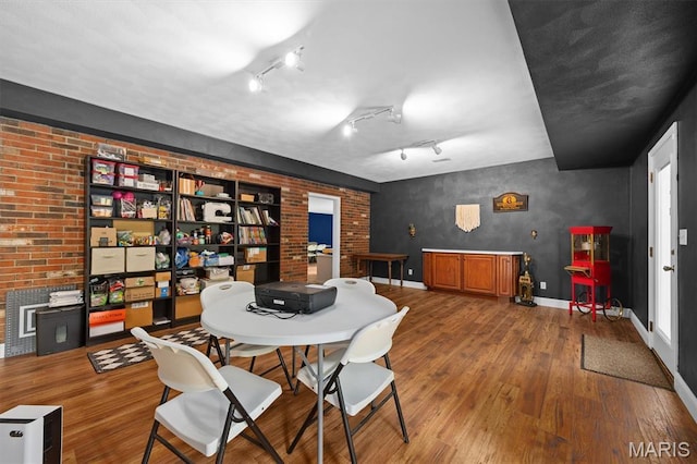 101 E Fairway Dr, Belleville, IL 62223 - dining room featuring wood finished floors and brick wall
